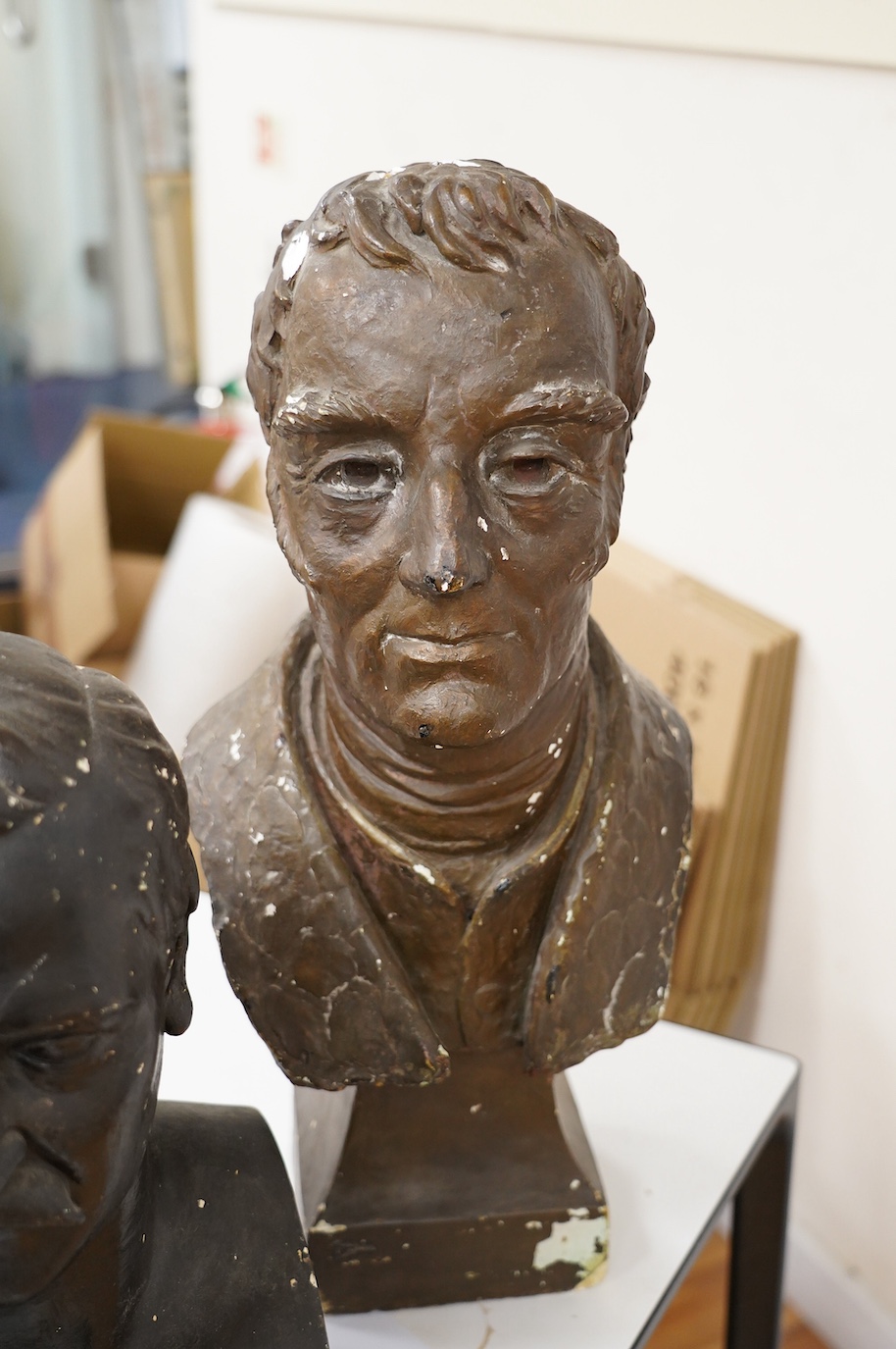 Three decorative plaster busts; the Duke of Wellington, 60cm high, another male figure, and a child. Condition - poor